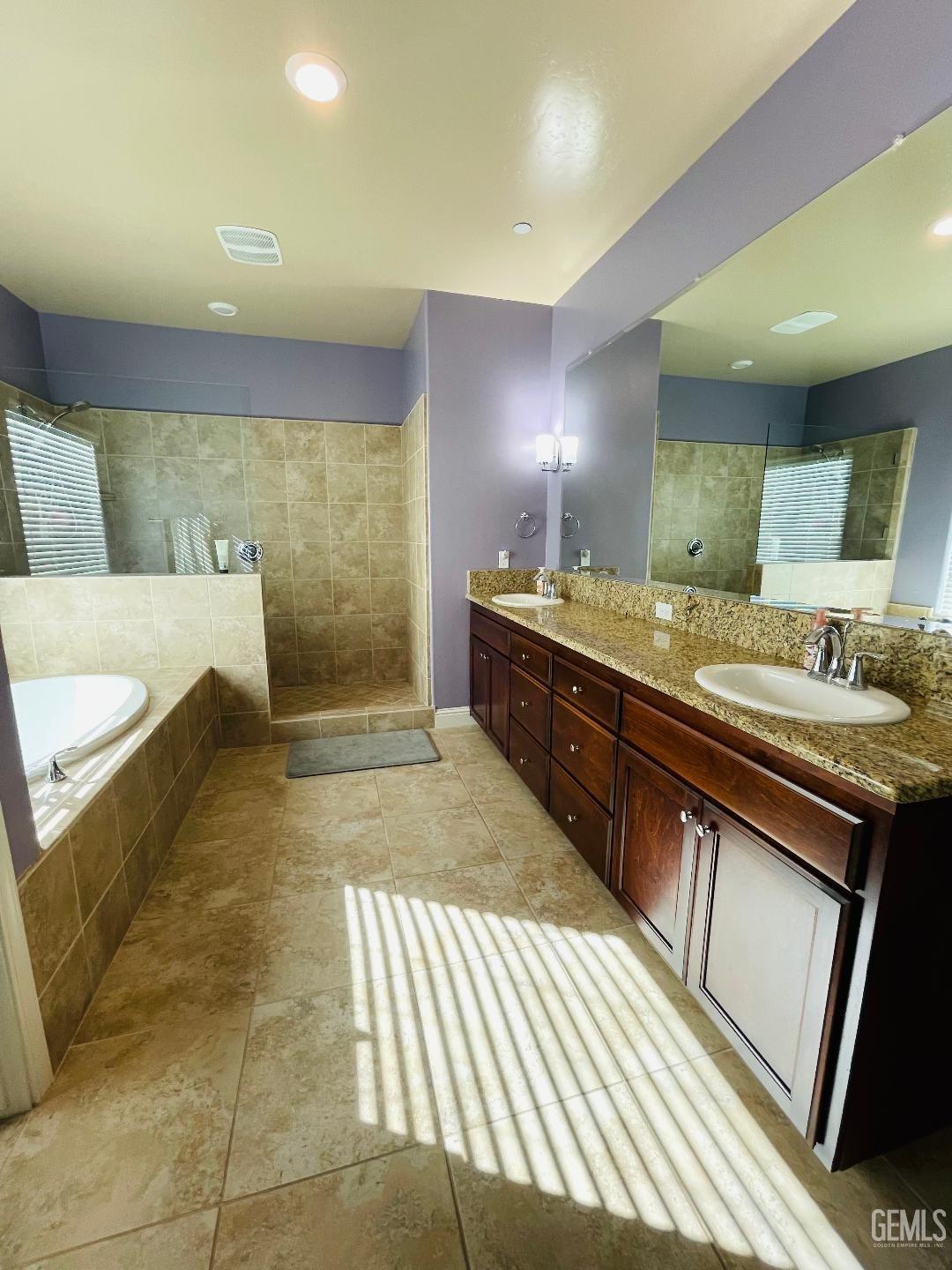 Undisclosed Address Shafter, CA 93263 - Photo 15 of 31 a spacious bathroom with a granite countertop sink a toilet a mirror and bathtub