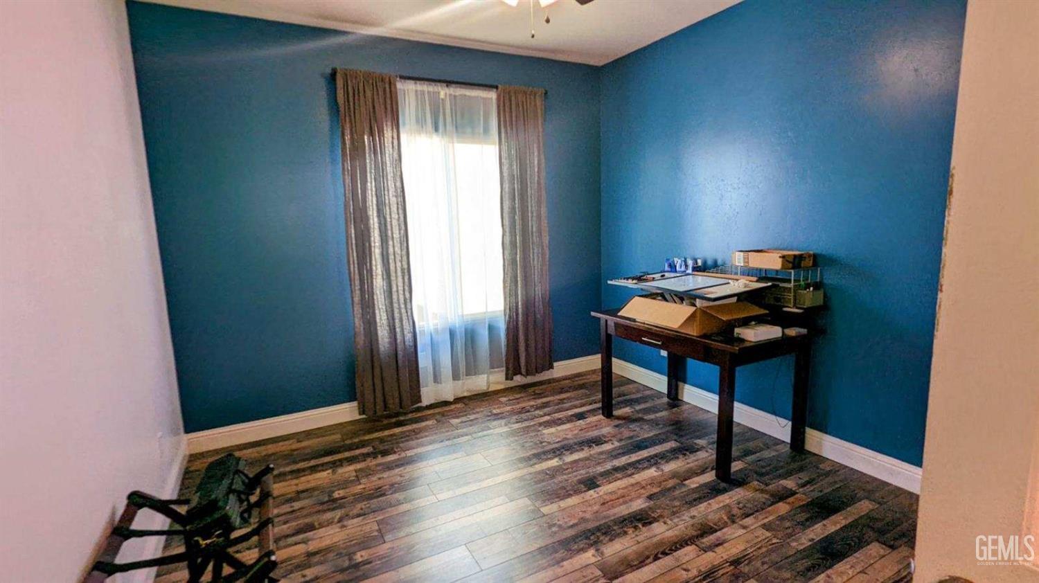 Undisclosed Address Shafter, CA 93263 - Photo 17 of 31 a room with wooden floor and furniture