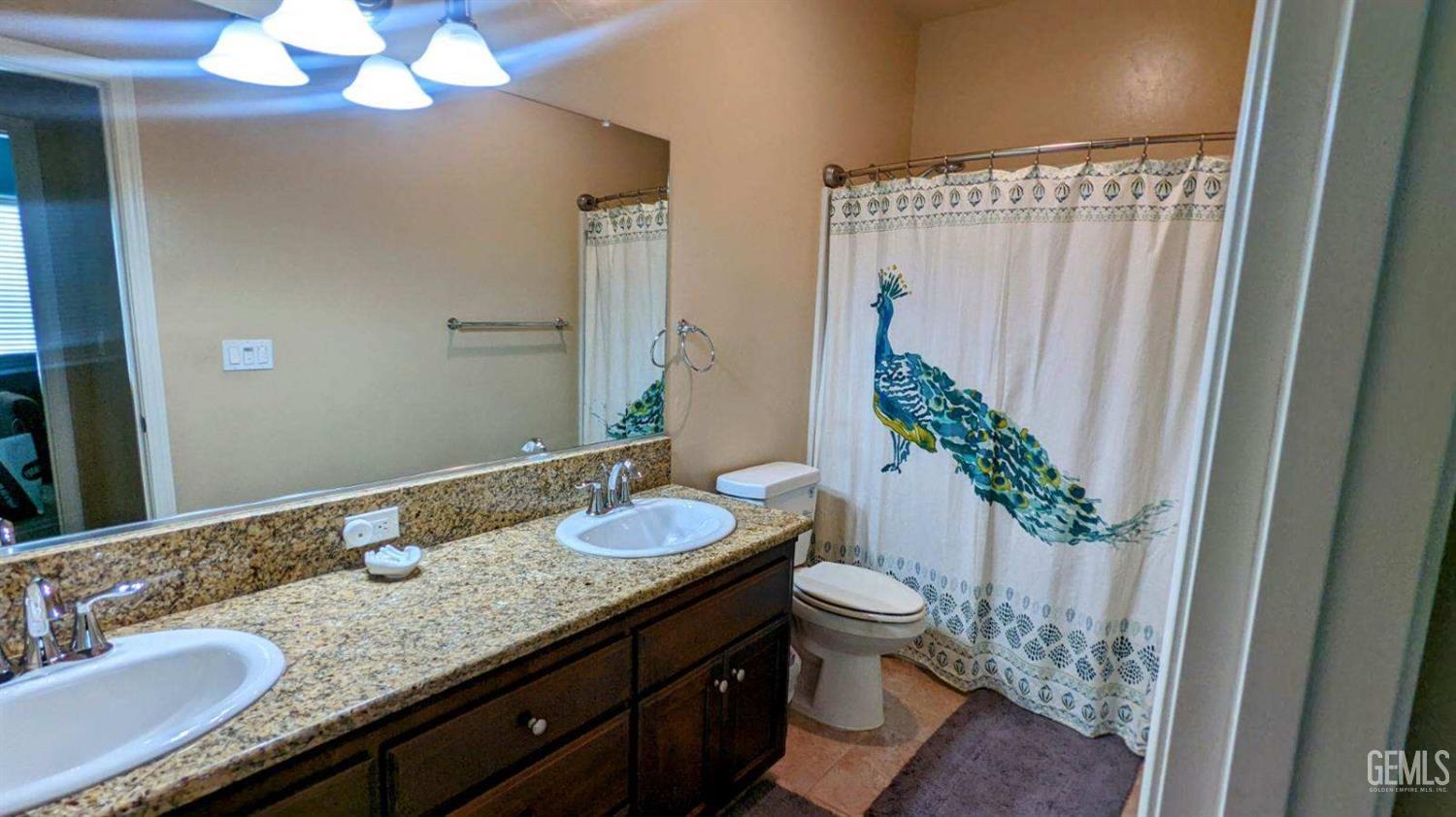 Undisclosed Address Shafter, CA 93263 - Photo 19 of 31 a bathroom with a granite countertop sink and a mirror