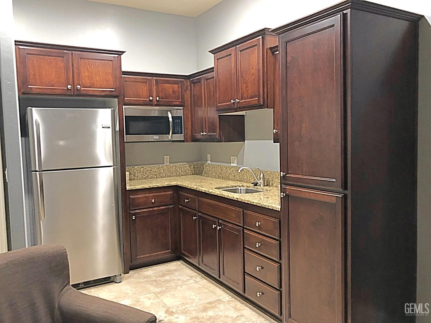 Undisclosed Address Shafter, CA 93263 - Photo 22 of 31 a kitchen with stainless steel appliances granite countertop a refrigerator and a sink