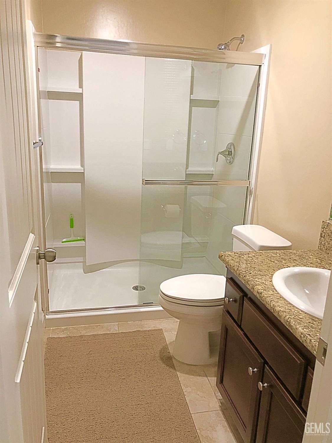 Undisclosed Address Shafter, CA 93263 - Photo 26 of 31 a bathroom with a granite countertop sink toilet and shower