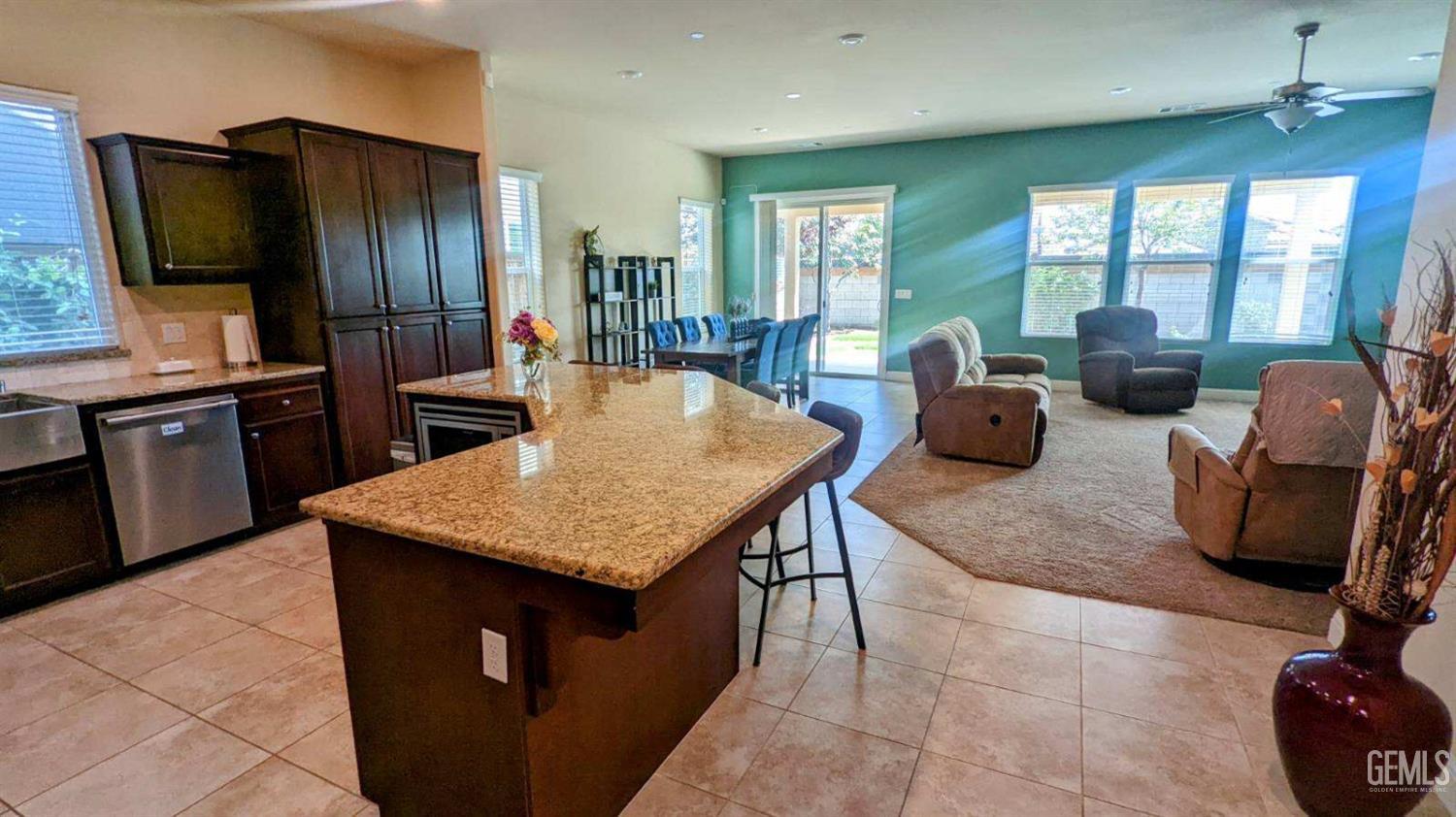 Undisclosed Address Shafter, CA 93263 - Photo 4 of 31 a kitchen with granite countertop cabinets a sink a counter space and living room