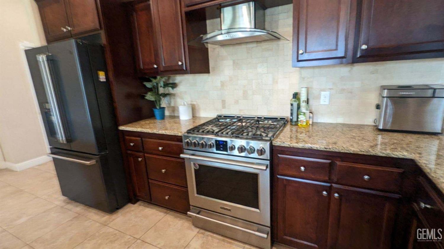 Undisclosed Address Shafter, CA 93263 - Photo 7 of 31 a kitchen with granite countertop stainless steel appliances and wooden cabinets