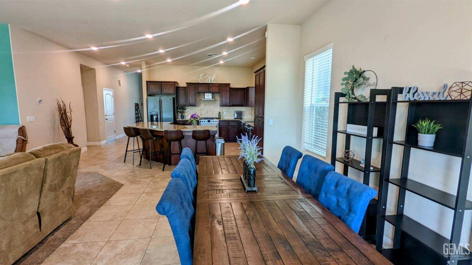 Undisclosed Address Shafter, CA 93263 - Photo 9 of 31 a view of a dining room with furniture and wooden floor