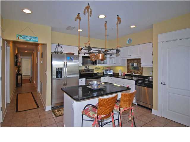 B302 Seacrest Blvd Inlet Beach, Unit B302 Inlet Beach, FL 32461 - Photo 12 of 19 a kitchen with stainless steel appliances granite countertop a sink a stove and a refrigerator