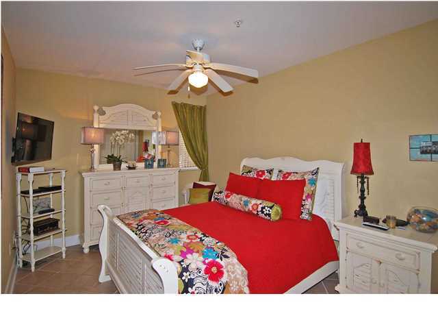 B302 Seacrest Blvd Inlet Beach, Unit B302 Inlet Beach, FL 32461 - Photo 5 of 19 a bedroom with a bed and a chandelier