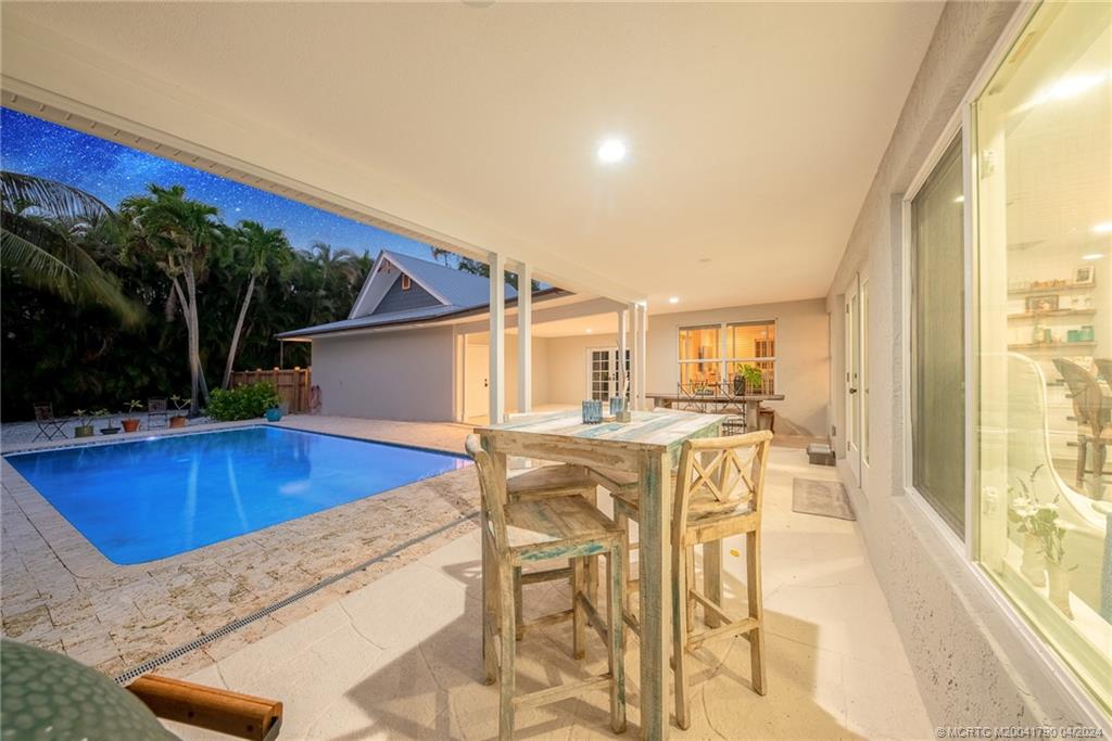 85 South Sewalls Point Road Sewall's Point, FL 34996 - Photo 24 of 34 a view of a patio with swimming pool table and chairs