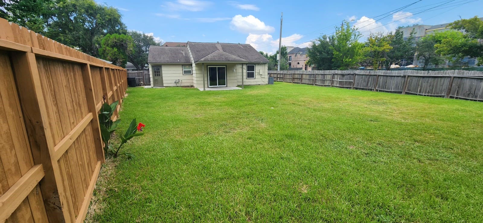 5501 Huisache Street Houston, TX 77081 - Photo 12 of 15 a view of a house with a yard and a patio