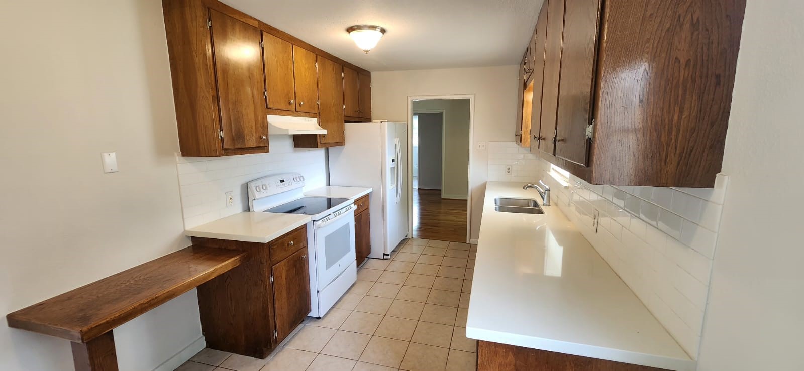 5501 Huisache Street Houston, TX 77081 - Photo 3 of 15 a kitchen with stainless steel appliances granite countertop a sink and a refrigerator