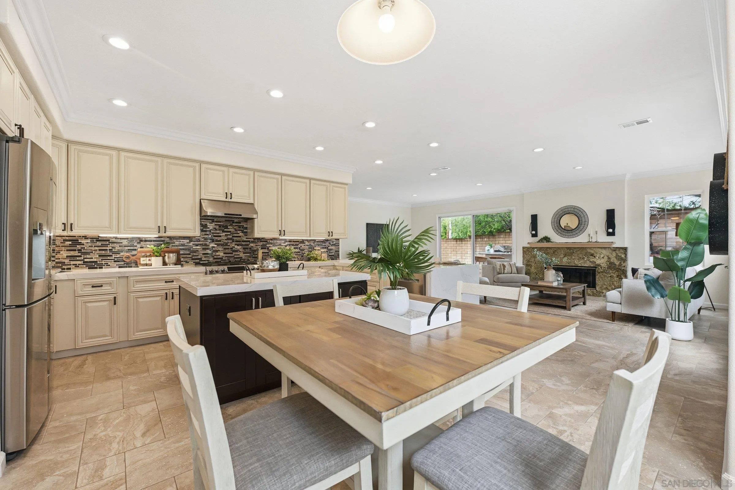 12632 Footman Lane Poway, CA 92064 - Photo 25 of 48 a kitchen with a table chairs stove and white cabinets