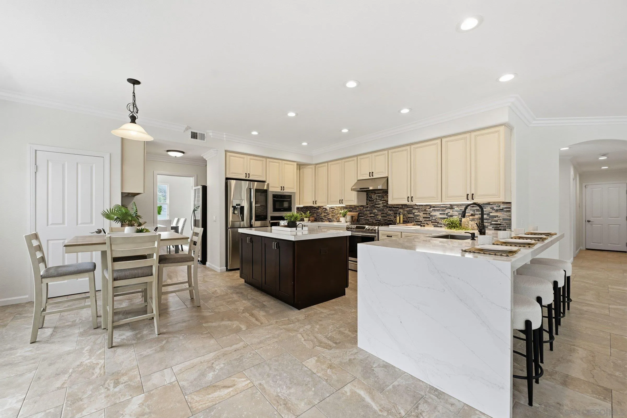 12632 Footman Lane Poway, CA 92064 - Photo 3 of 48 a kitchen with kitchen island stainless steel appliances a sink a counter top space and cabinets