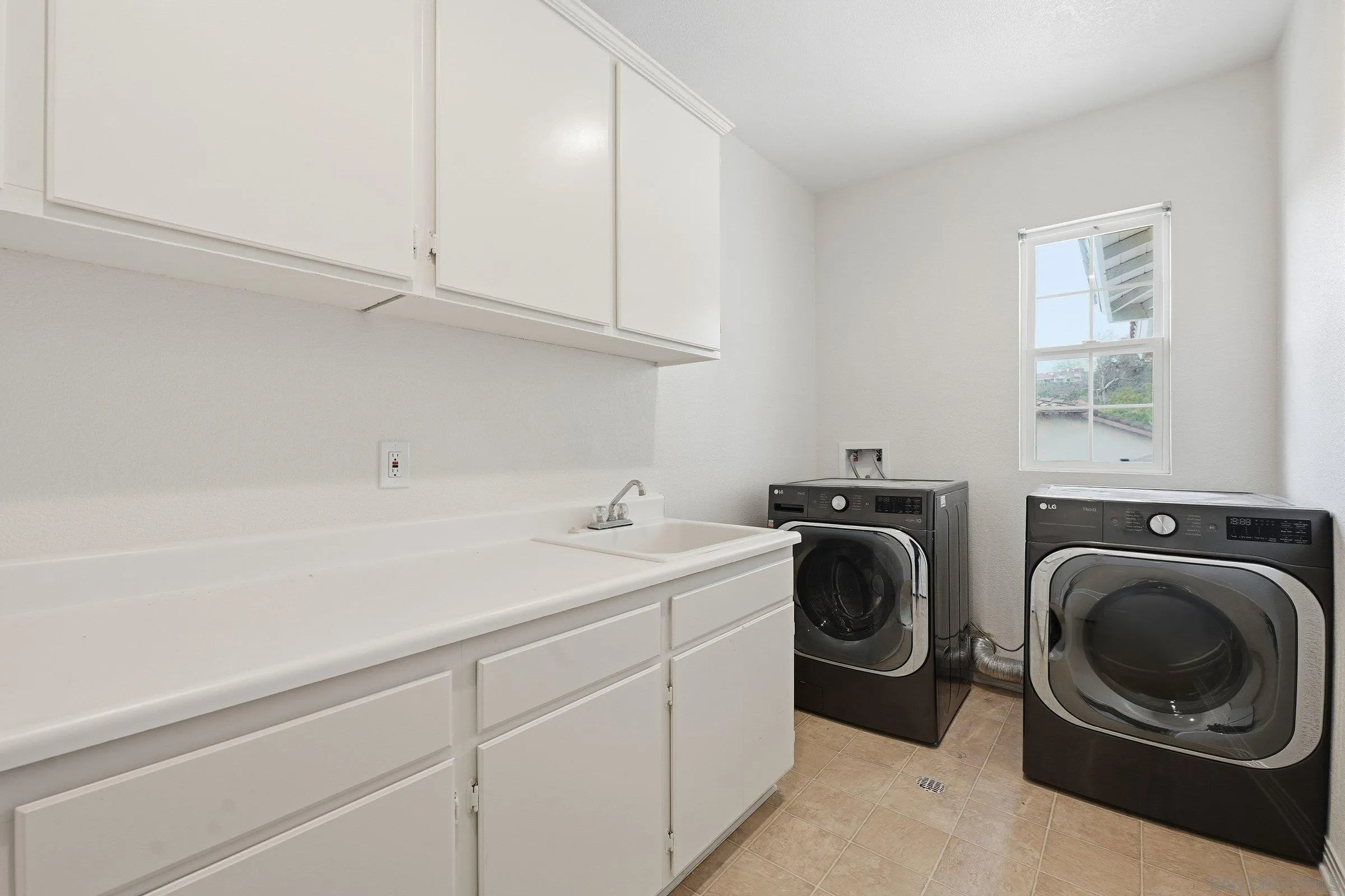 12632 Footman Lane Poway, CA 92064 - Photo 37 of 48 a utility room with sink dryer and washer