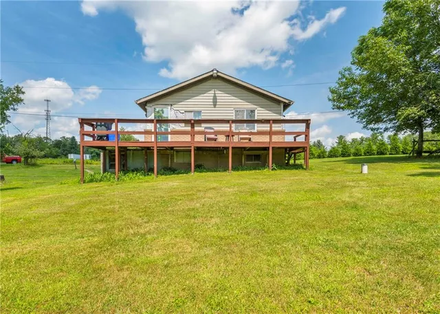 a view of a house with a yard table and chairs