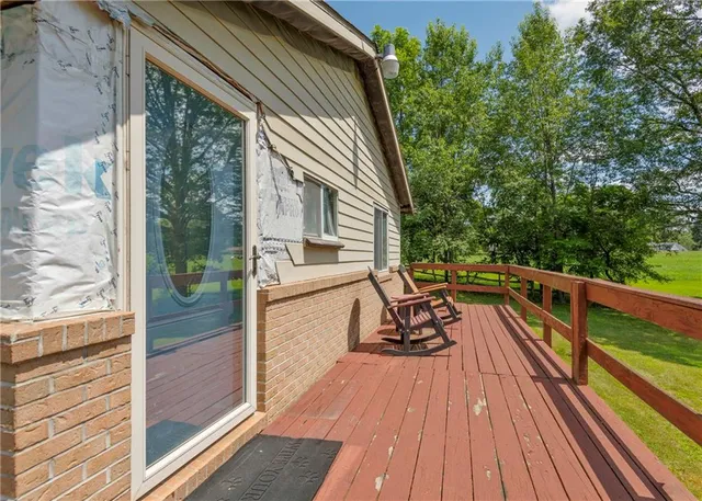 a view of swimming pool with a bench and trees