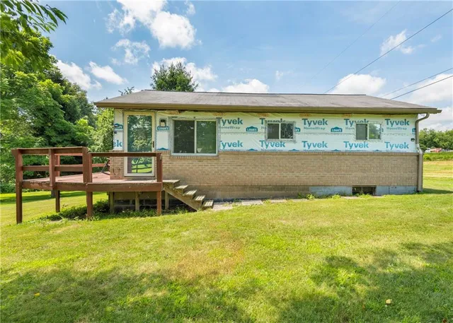 a view of a house with pool and a yard