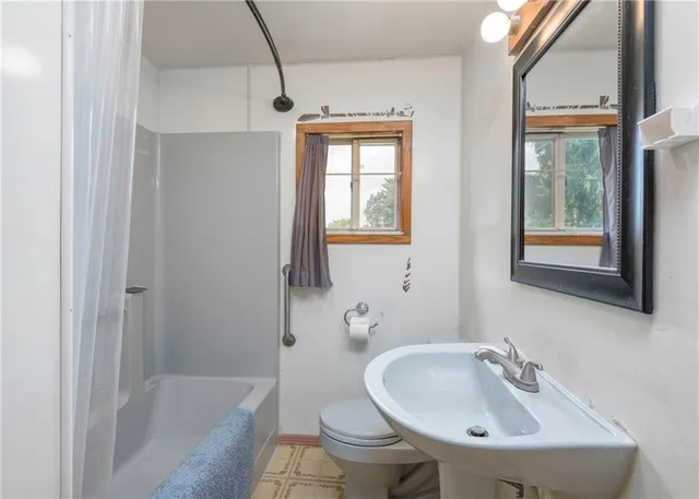 a room with gym equipment and view of living room