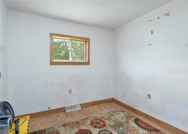 a living room with stainless steel appliances kitchen island granite countertop furniture and a refrigerator