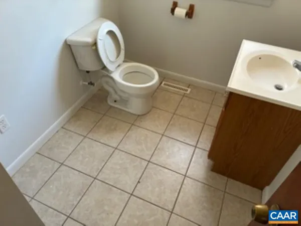 a bathroom with a sink toilet and mirror