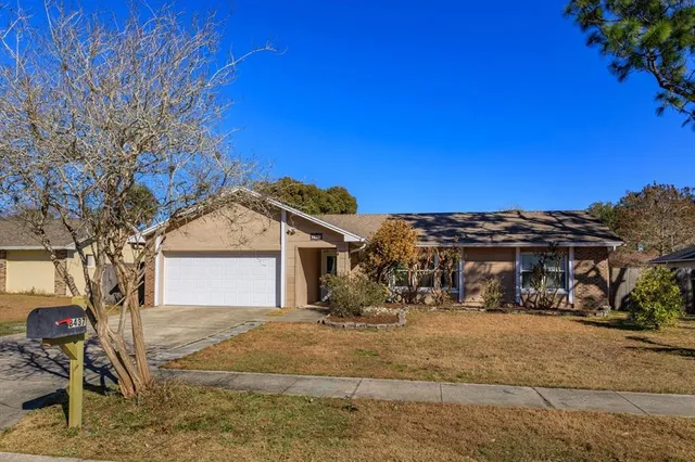 a view of a white house with a snow in the yard