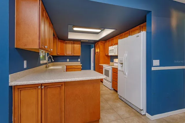 a kitchen with stainless steel appliances granite countertop wooden cabinets and a counter top space