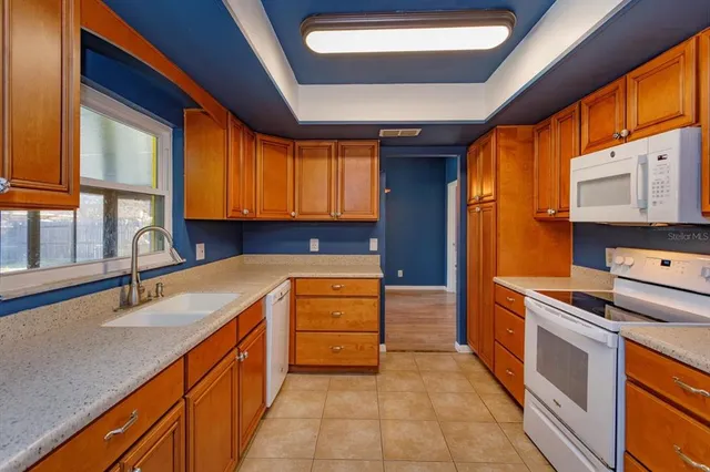 a kitchen with a sink a stove and cabinets