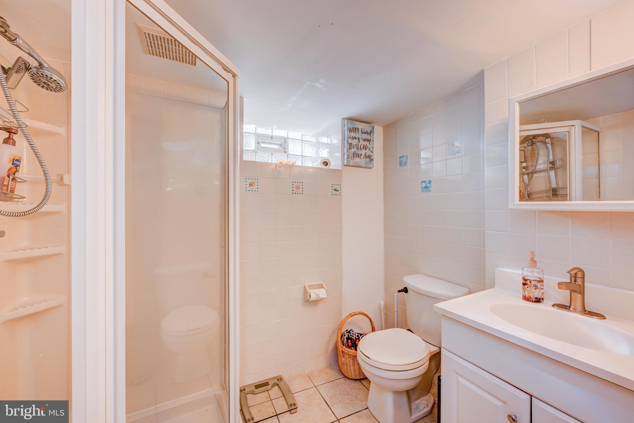 14 Summit Avenue Wyncote, PA 19095 - Photo 25 of 36 a bathroom with a granite countertop toilet a sink and a mirror