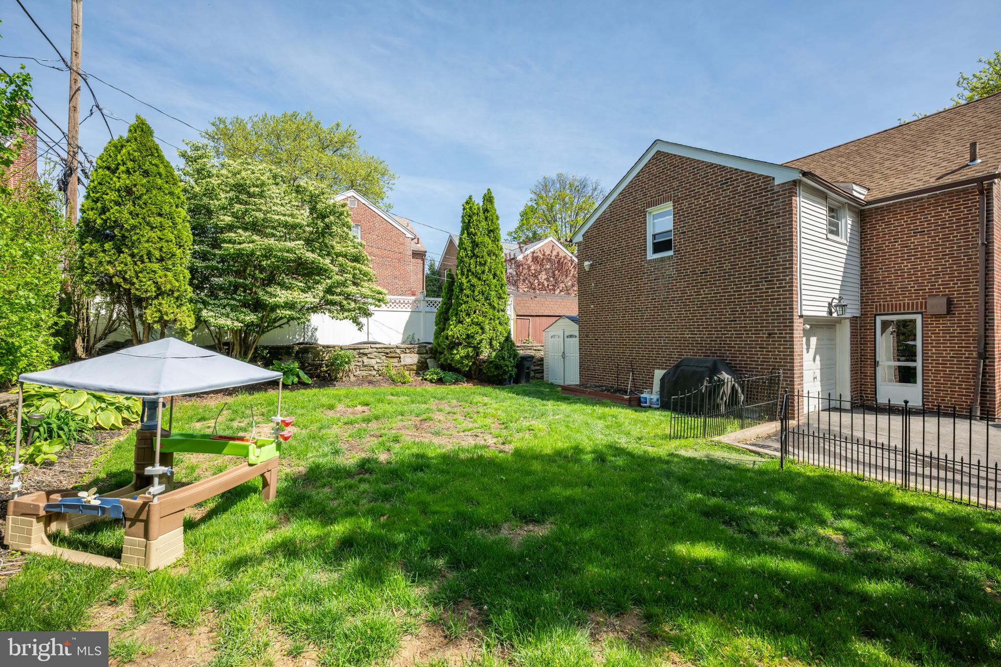 14 Summit Avenue Wyncote, PA 19095 - Photo 30 of 36 a backyard of a house with table and chairs under an umbrella