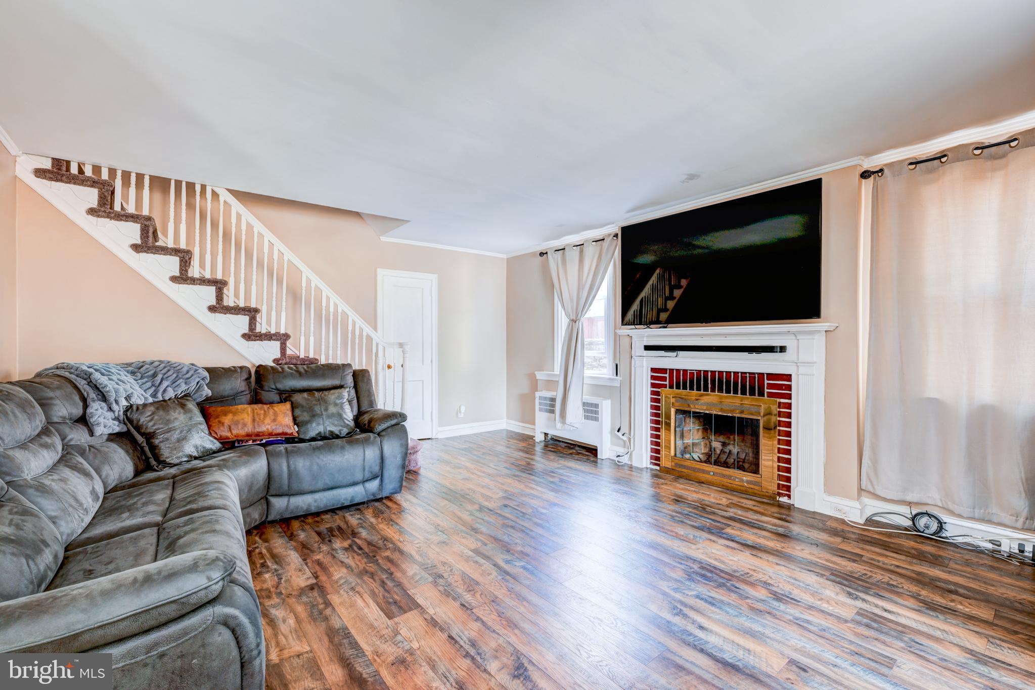 14 Summit Avenue Wyncote, PA 19095 - Photo 4 of 36 a living room with furniture a flat screen tv and a fireplace