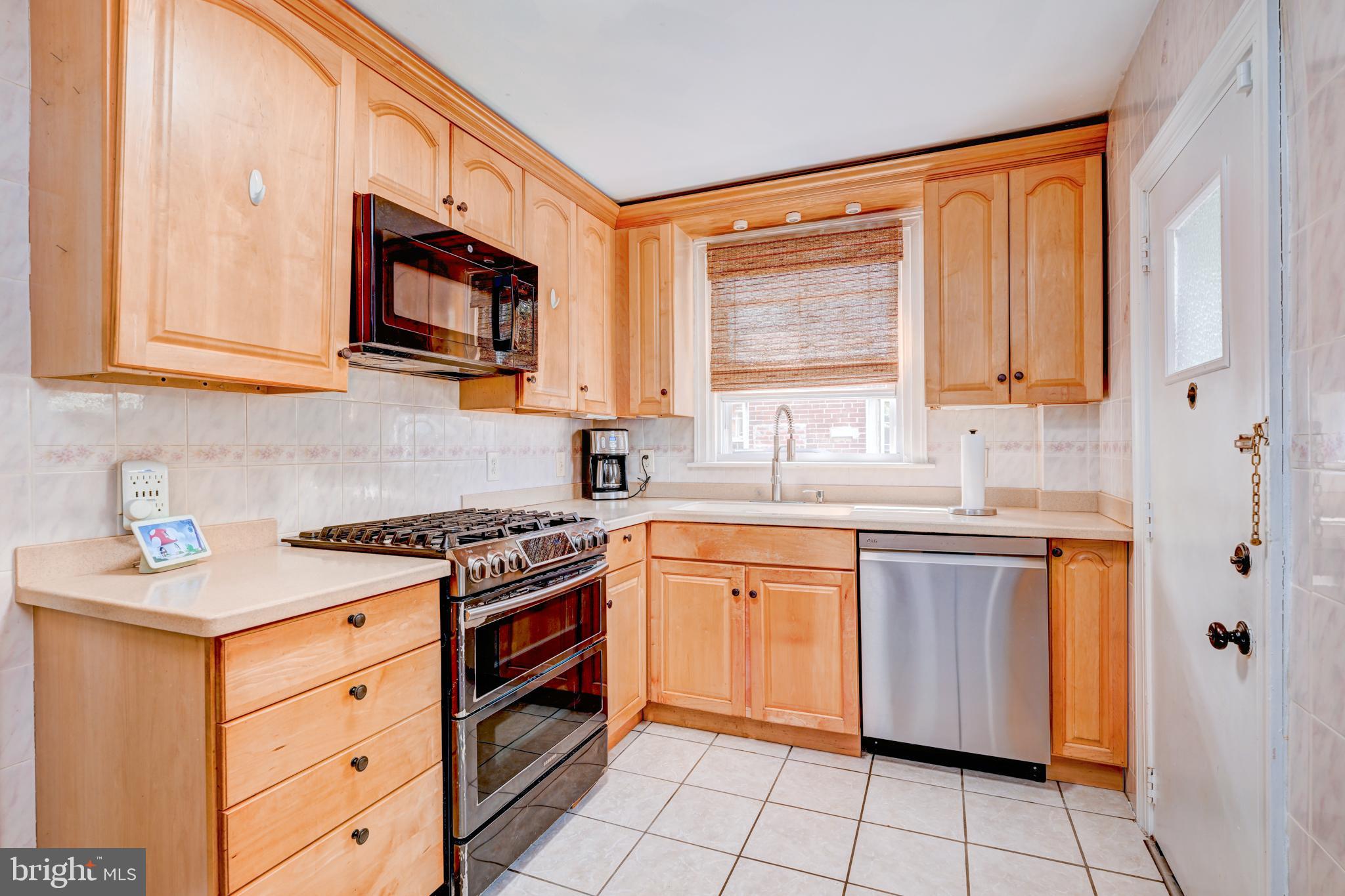 14 Summit Avenue Wyncote, PA 19095 - Photo 10 of 36 a kitchen with stainless steel appliances granite countertop a sink and a stove top oven