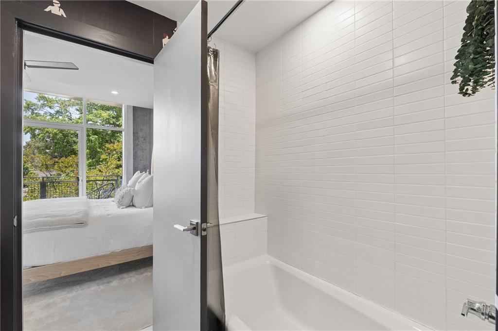752 Moreland Avenue Southeast, Unit 4 Atlanta, GA 30316 - Photo 28 of 58 a bathroom with a tub and a window