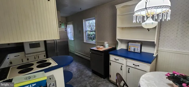 a kitchen with a sink appliances and cabinets