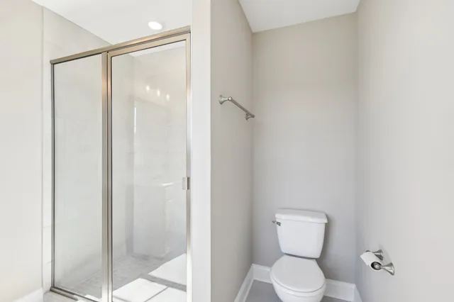 a bathroom with a toilet and shower