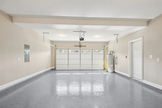 a view of an empty room with window and chandelier fan