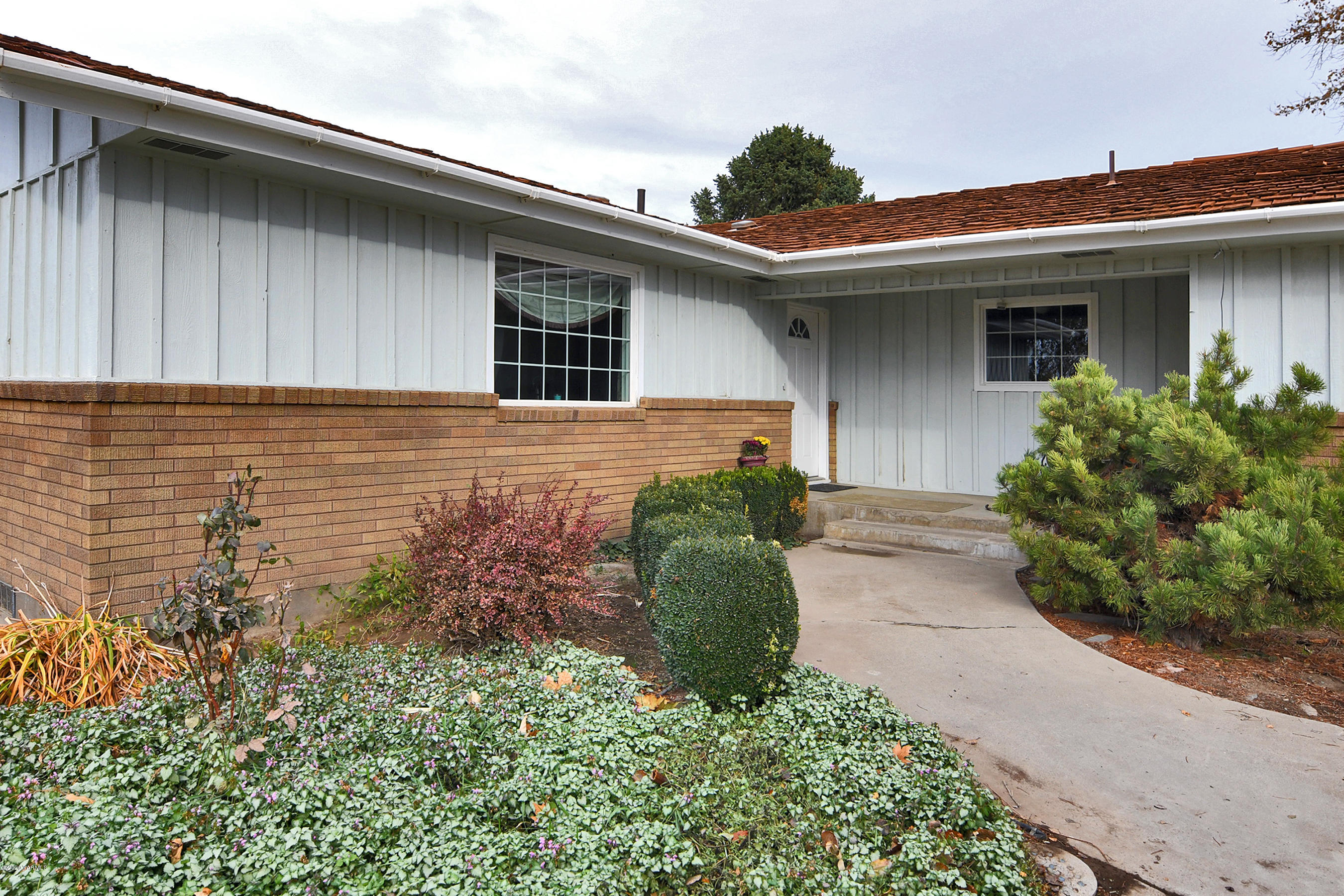 a front view of a house with garden
