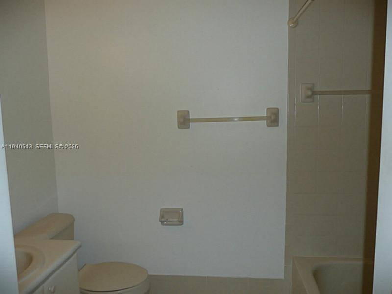 15655 Southwest 41st Street, Unit 201 Miramar, FL 33027 - Photo 2 of 18 a white toilet sitting next to a shower