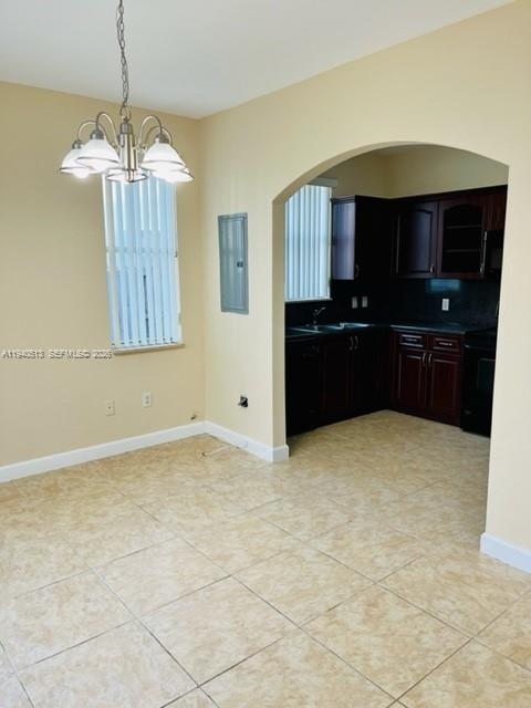 15655 Southwest 41st Street, Unit 201 Miramar, FL 33027 - Photo 6 of 18 a kitchen with a stove a refrigerator and a sink