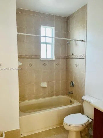 a bathroom with a toilet and bathtub