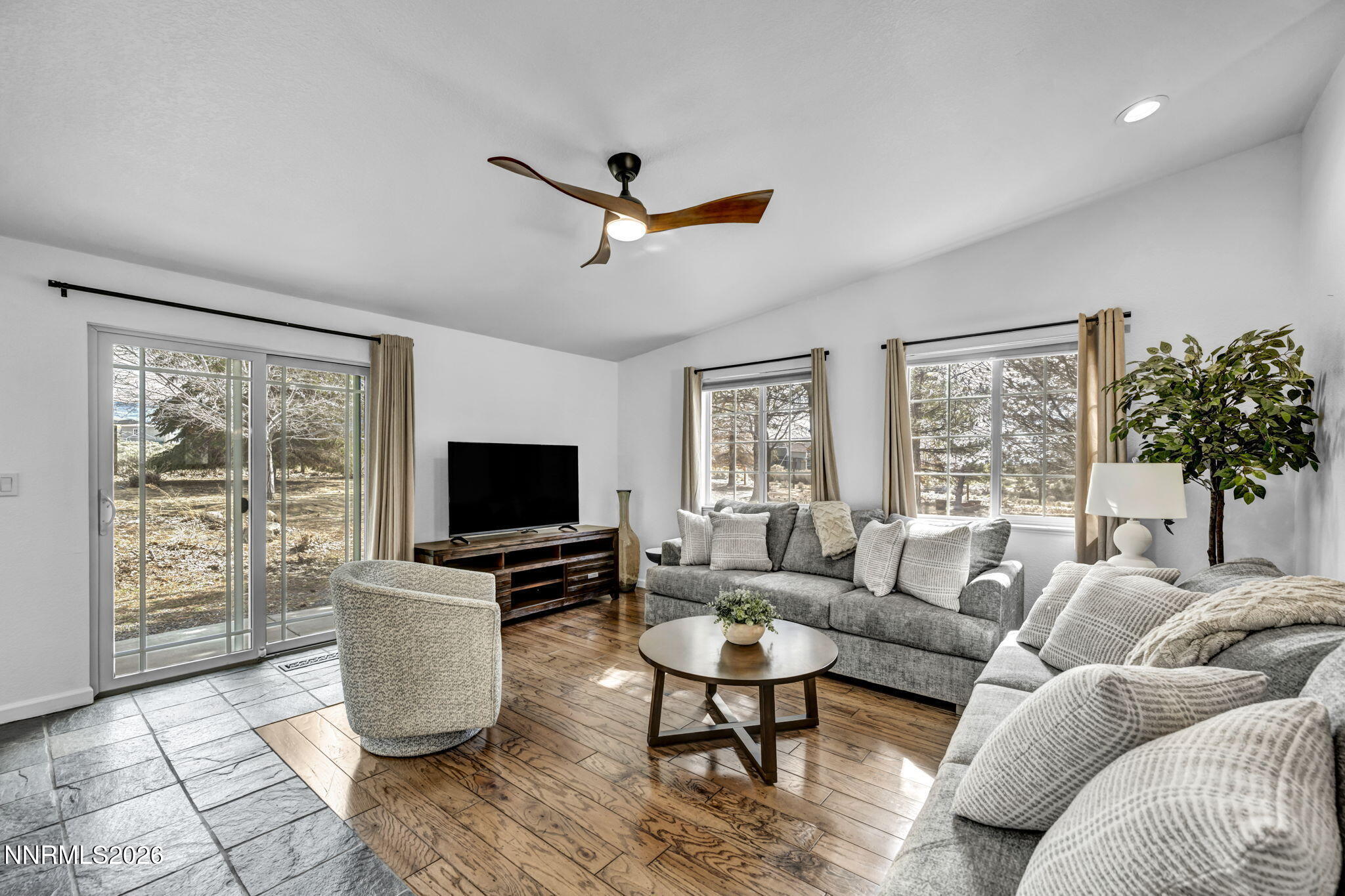 11680 Campo Rico Lane Sparks, NV 89441 - Photo 16 of 61 a living room with furniture a large window and a flat screen tv