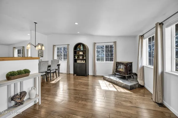 a view of a livingroom with wooden floor and furniture