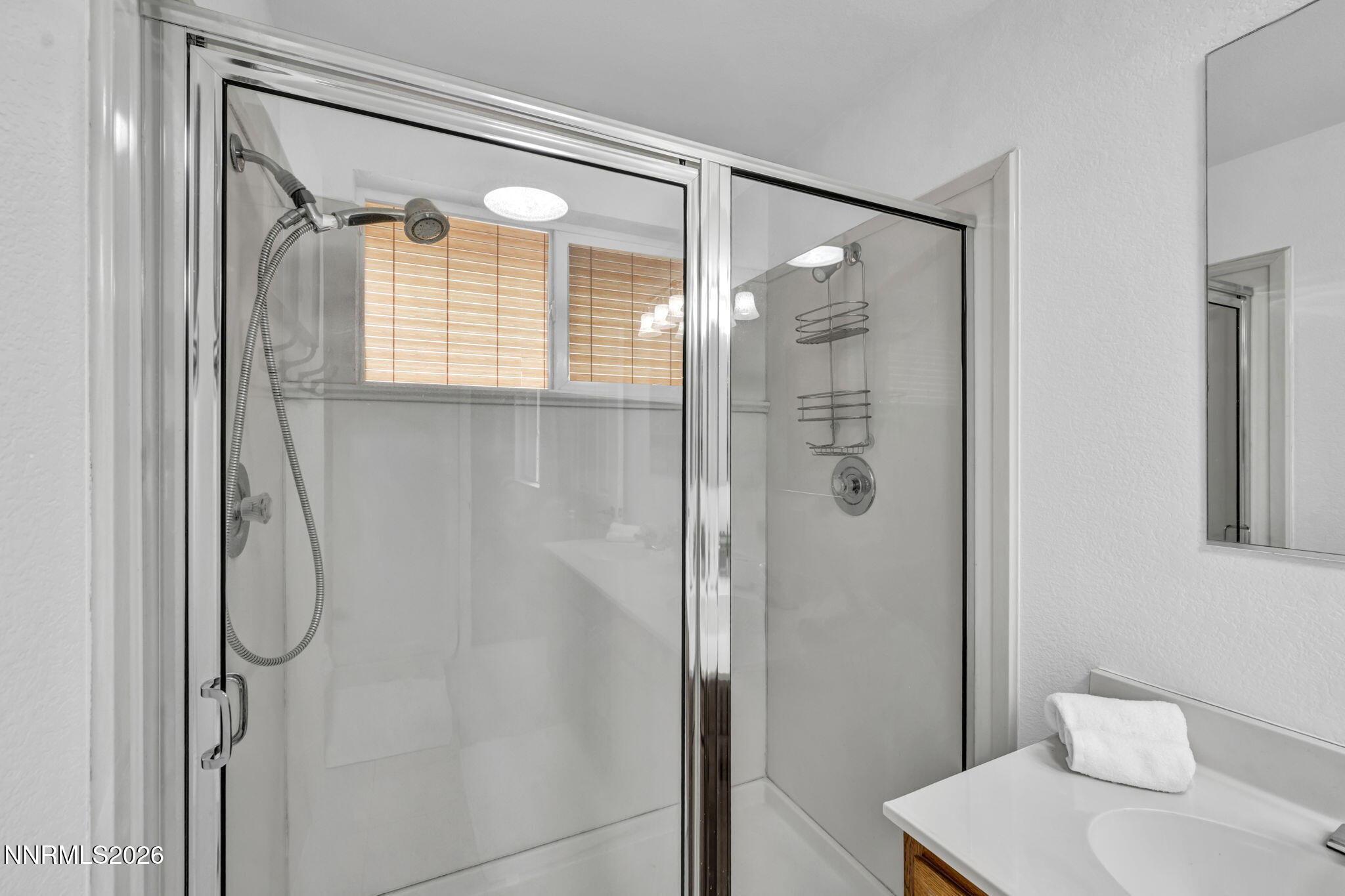 11680 Campo Rico Lane Sparks, NV 89441 - Photo 33 of 61 a bathroom with a shower and a mirror