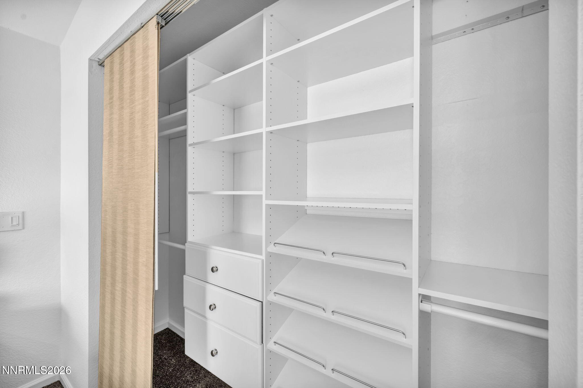11680 Campo Rico Lane Sparks, NV 89441 - Photo 34 of 61 a view of walk in closet with empty racks