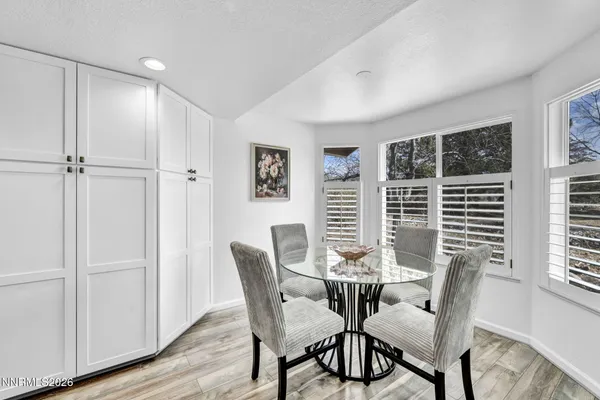 a view of a dining room with furniture window and wooden floor