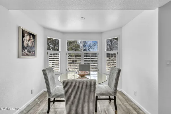 a bathroom with a glass shower door and a table