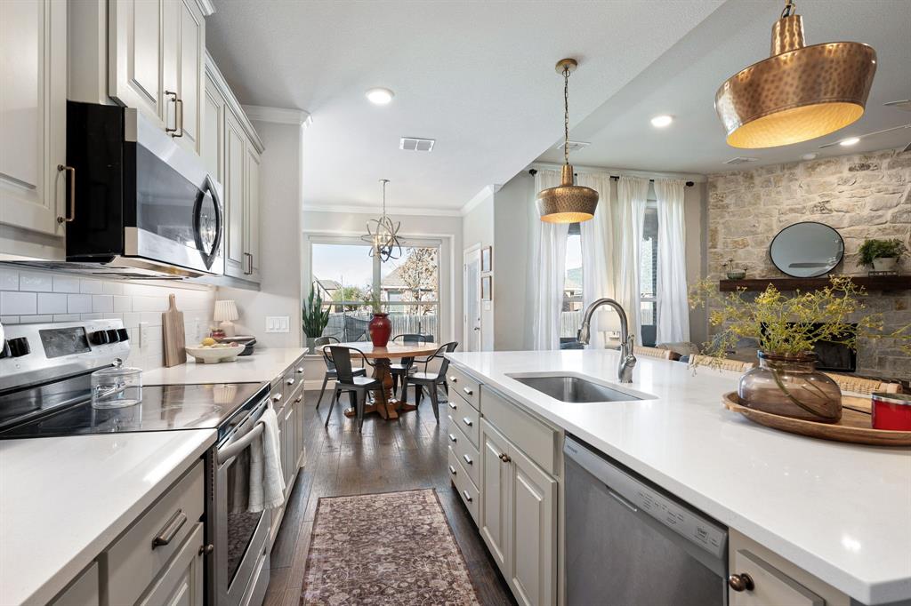 3024 Treasure View Drive Decatur, TX 76234 - Photo 11 of 22 a kitchen with counter top space a sink appliances and cabinets