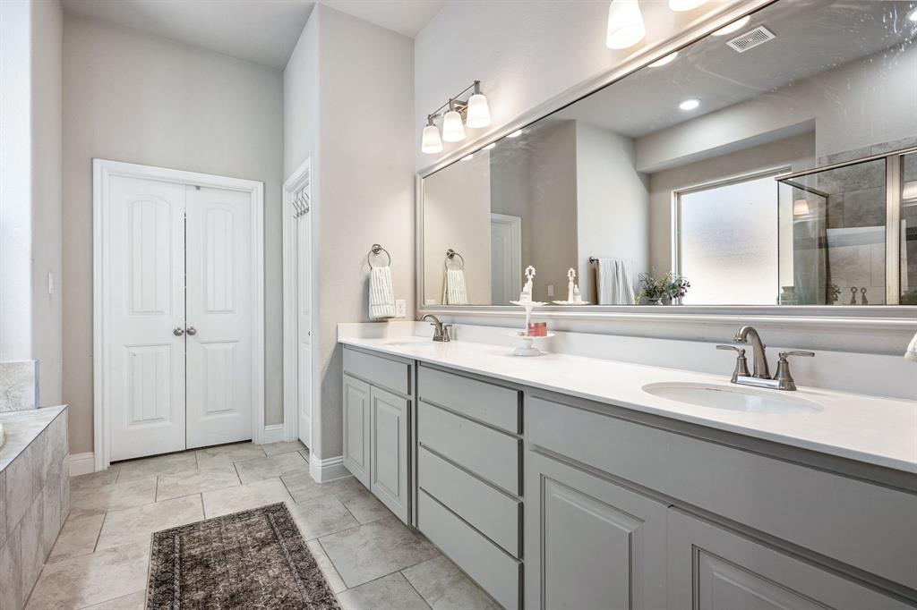 3024 Treasure View Drive Decatur, TX 76234 - Photo 15 of 22 a bathroom with a double vanity sink a mirror and a