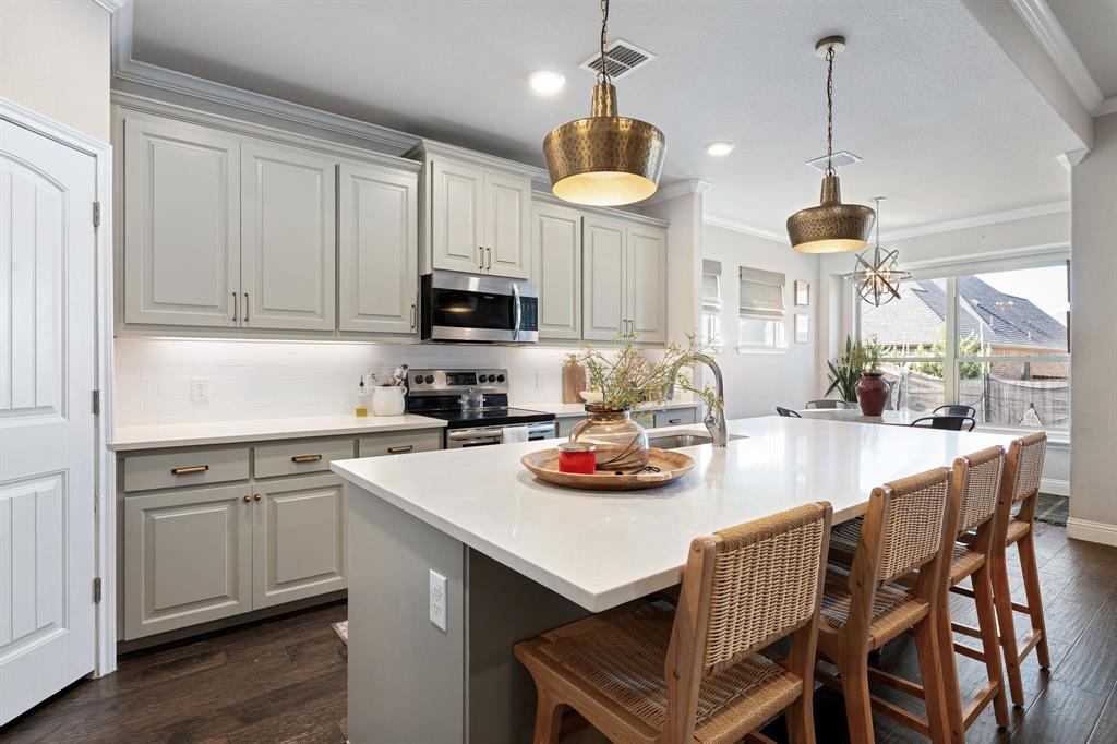 3024 Treasure View Drive Decatur, TX 76234 - Photo 9 of 22 a kitchen with a dining table chairs and white cabinets