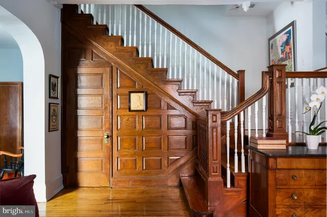a view of entryway and hall with wooden floor