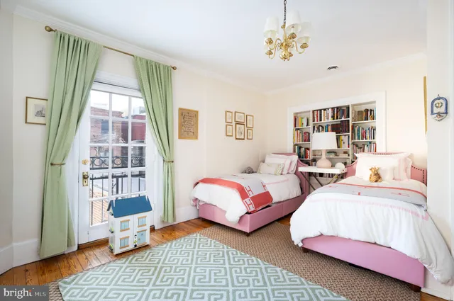 a bedroom with two beds and a window