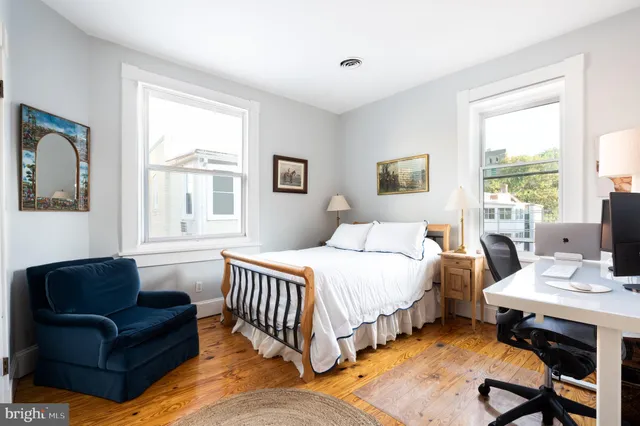 a bedroom with a bed couch and a window