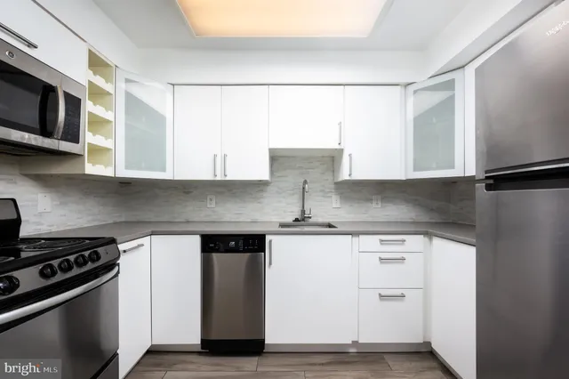 a kitchen with stainless steel appliances a sink stove and microwave